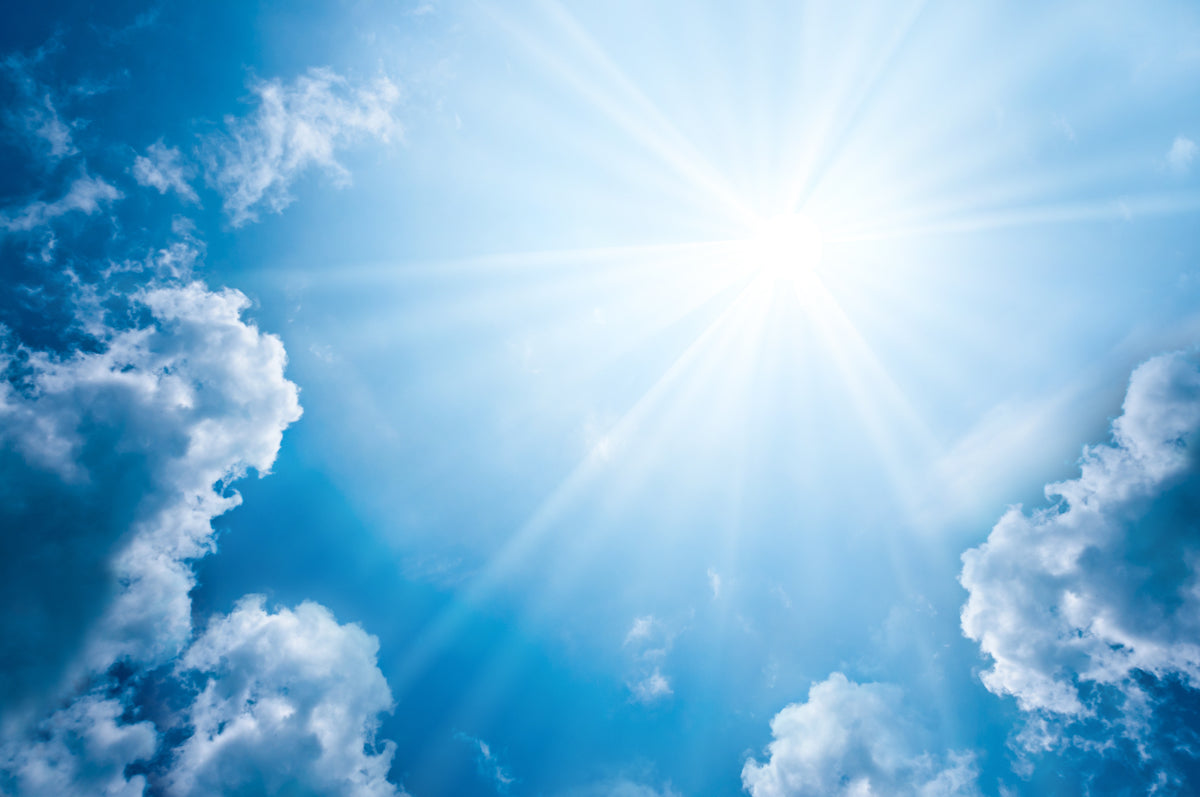 Bright Sun Rays Through Blue Sky & Clouds