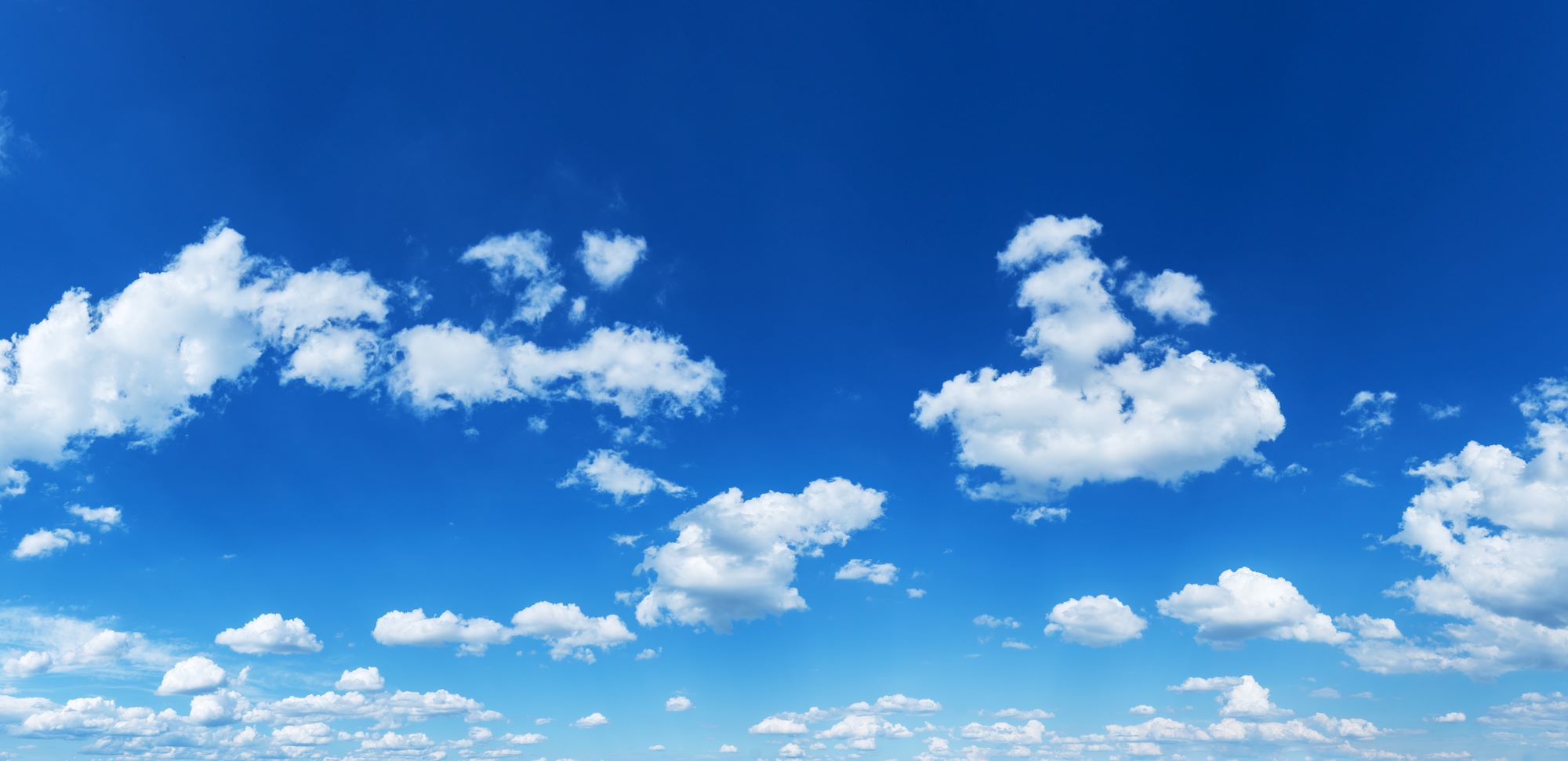 Clear Blue Sky with Soft White Clouds