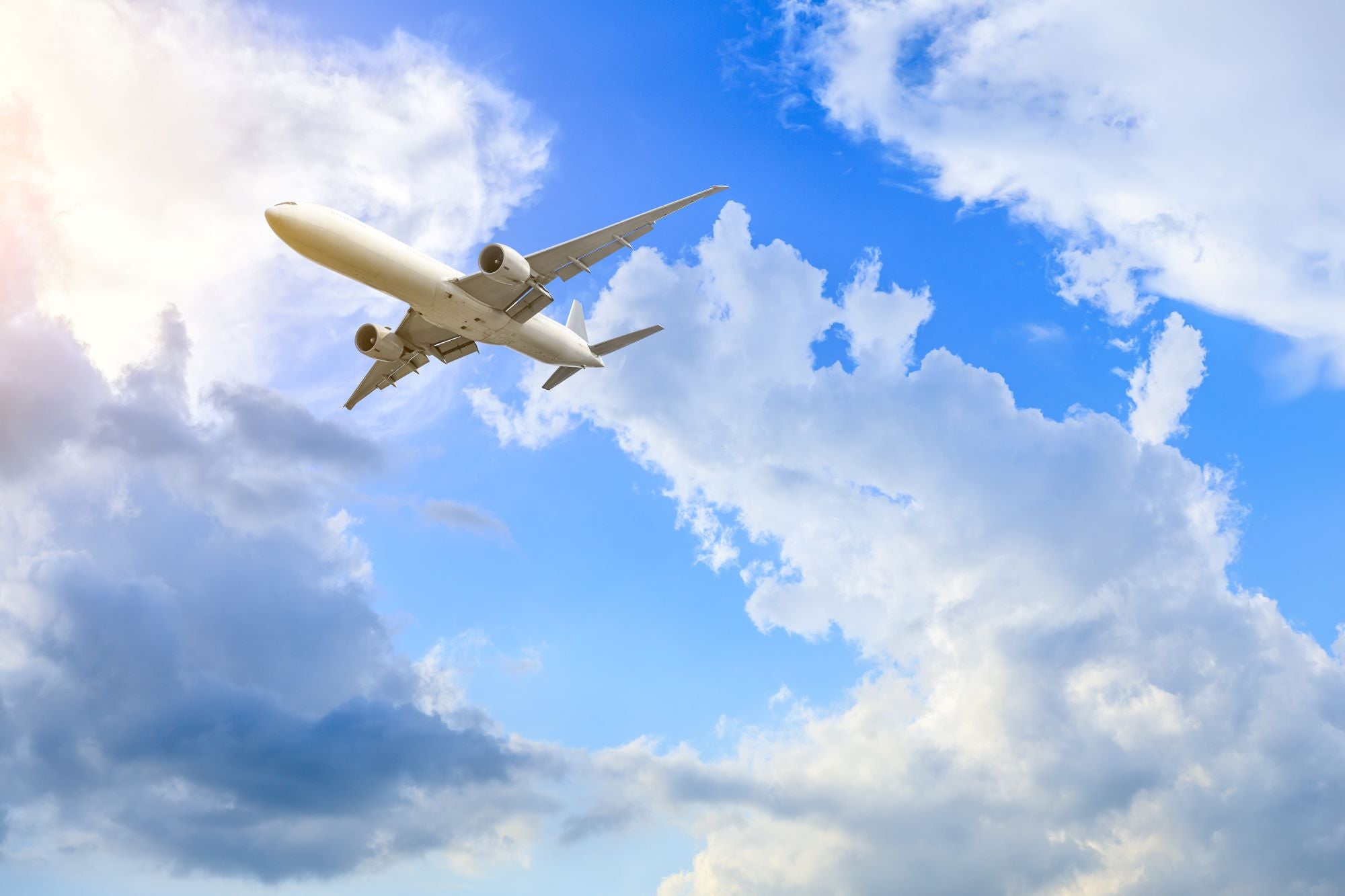 Airplane Flying High in Blue Sky