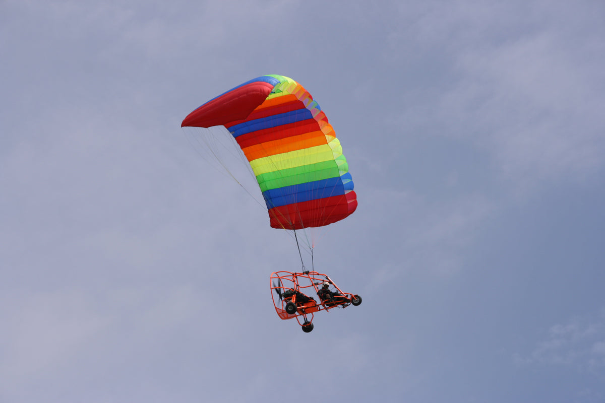 Rainbow Paramotor Glider Against Clear Sky