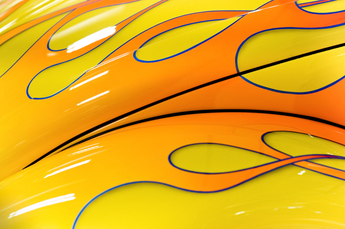 Yellow-Orange Flame Graphic on Glossy Car Surface