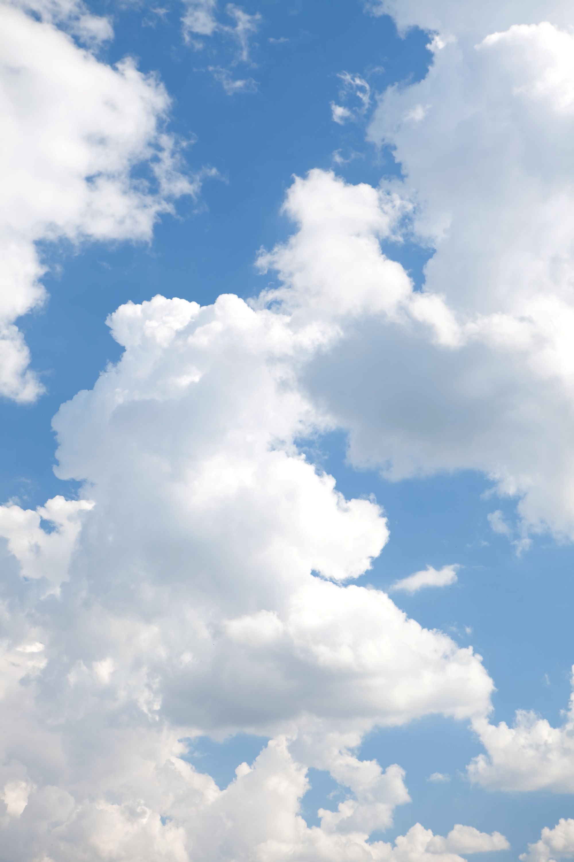Bright Blue Sky with Soft Floating Clouds