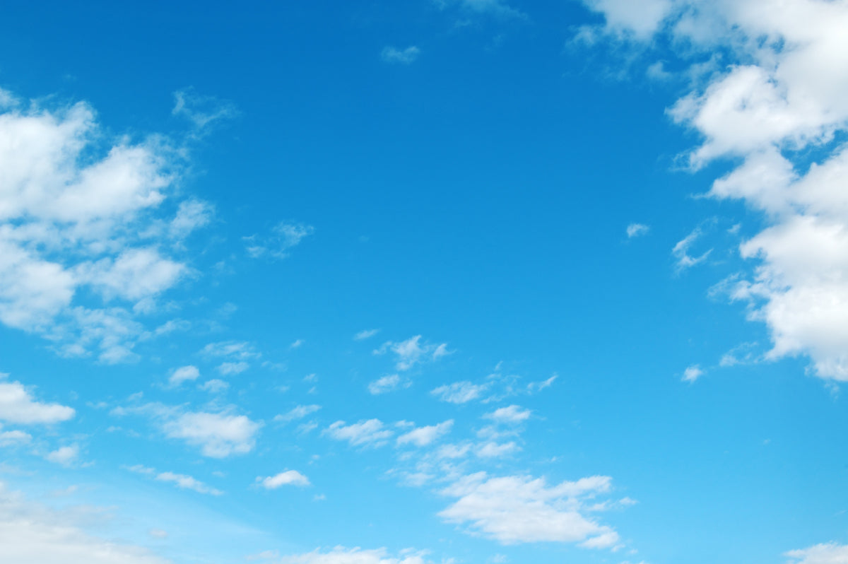 Bright Blue Sky with Scattered White Clouds Design