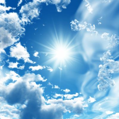 Radiant Sunlight Breaking Through Blue Sky Clouds