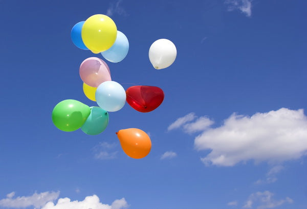 Colorful Balloons Floating in a Clear Blue Sky