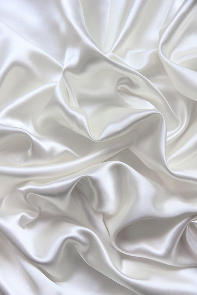 Smooth White Satin Fabric with Elegant Folds