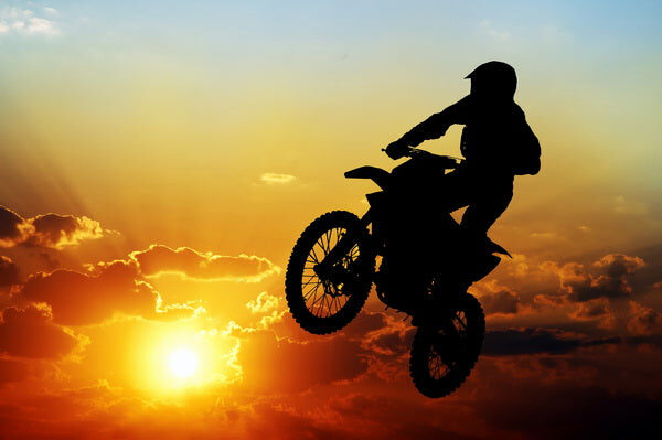 Motocross Rider in Sunset Flight