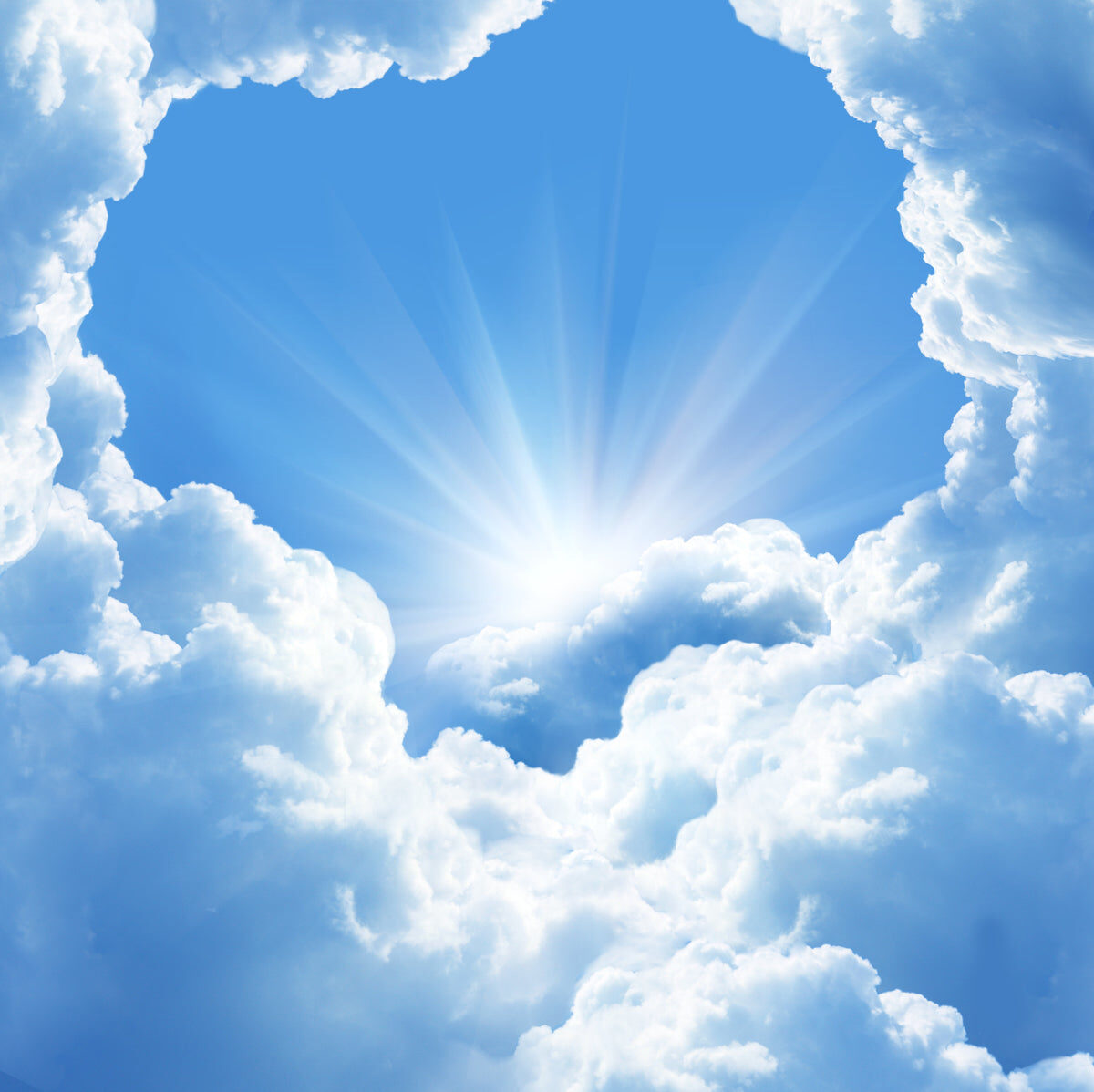 Sunlight Breaking Through Fluffy Blue Clouds