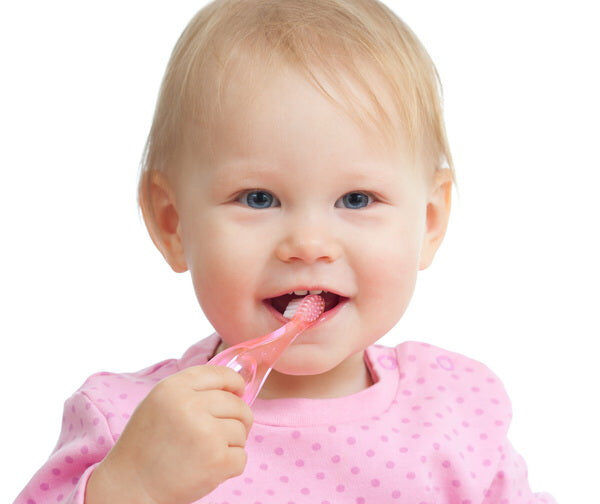 Toddler Brushing Teeth with Pink Toothbrush